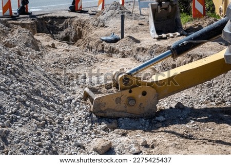A backhoe digging a trench