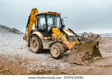 Backhoe excavator and bulldozer on construction site