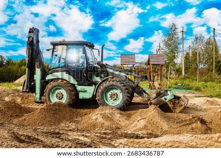 Backhoe is executing ground shaping work as part of site preparation process ensuring surface adjustment for further construction activity.