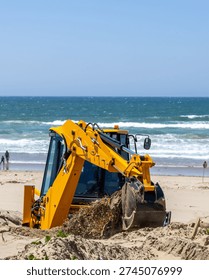 A Backhoe gets to work on the Beach