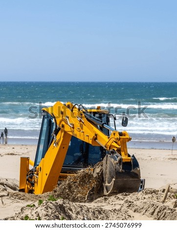 A Backhoe gets to work on the Beach