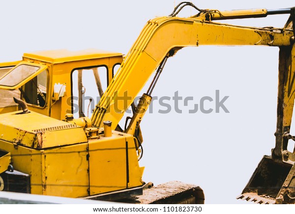 Backhoe, a large\
car used in construction, hard work, the site construction site on\
white background , soft\
focus.