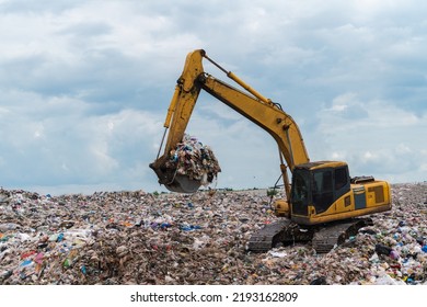 Backhoe Managing Garbage In A Landfill Site, Pollution Concept