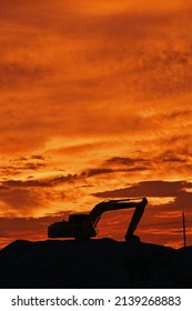 A Backhoe Silhouette At Sunset