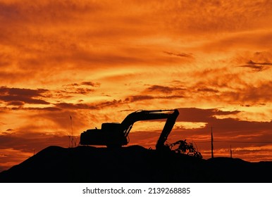 A Backhoe Silhouette At Sunset