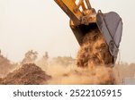 Backhoe working by digging soil at construction site bucket of crawler excavator breaking ground for new development project earth moving machine in action. Foundation work on construction project.