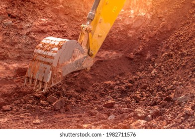 Backhoe Working By Digging Soil At Construction Site. Bucket Of Backhoe Digging Soil. Crawler Excavator Digging On Dirt. Closeup Backhoe Bucket Of Yellow Backhoe. Earthmoving. Trenching Machine.