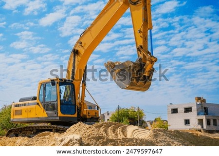 Backhoe working by digging soil at construction site. Bucket of backhoe digging soil. Crawler excavator digging on dirt.