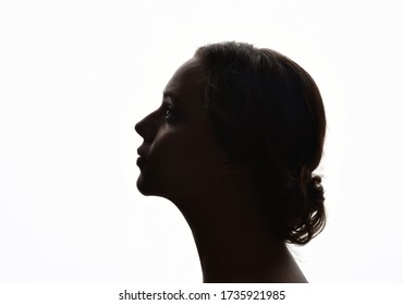 backlight, head and shoulders portrait of a female against white background. - Powered by Shutterstock