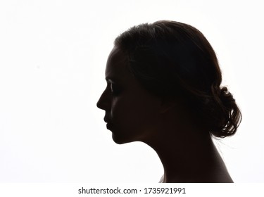 backlight, head and shoulders portrait of a female against white background.
