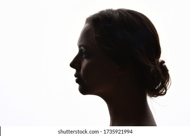 backlight, head and shoulders portrait of a female against white background.