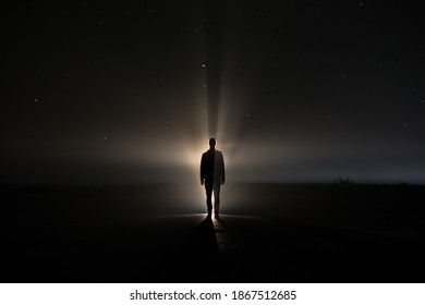 backlighting of a man in the dark of a foggy night and a light behind the model - Shutterstock ID 1867512685