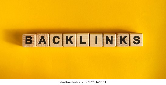 Backlinks Word Cube On A Yellow Background. Seo Concept.