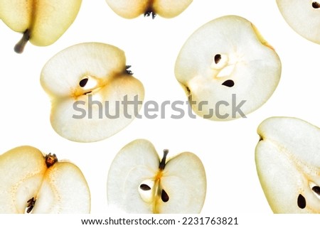 Backlit apple and pear slices. Sliced fruits on a white background.