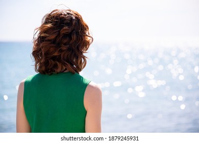 Backlit Of A Redheaded Woman Facing The Sea