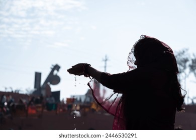 backlit shot of young devotee praying for holy god after bathing in holy river water at morning