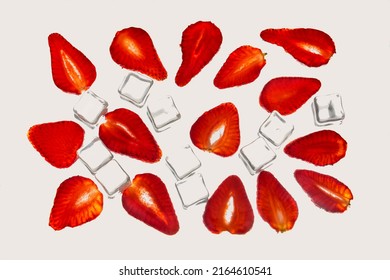 Backlit Slice Of Strawberry Arranged With Ice Cubes Food Concept. Studio Shot. Isolated On Bright Background