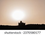 Backlit sunset view of the Mausoleum of Aga Khan, the tomb of Sultan Mahommed Shah Aga Khan III, located in the Egyptian city of Aswan
