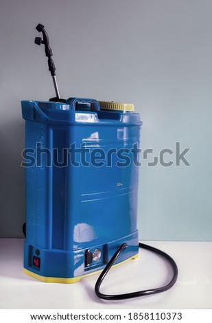 Backpack battery sprayer for protecting trees and plants from diseases and pests. The pressure is increased using a battery-powered pump. Close-up, copy space