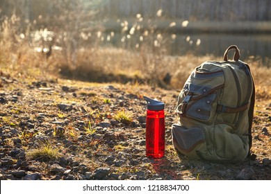 Backpack And Bottle With Water Outdoor. Hiking Concept.