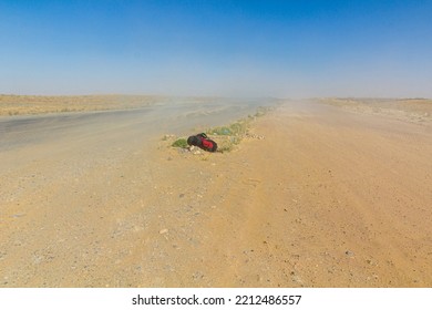 Backpack By A Road In Karakum Desert During A Dust Storm, Turkmenistan
