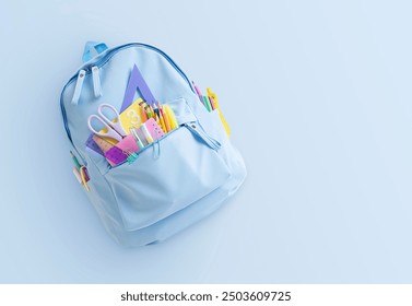 Backpack with colorful school supplies on light blue background with copy space - Powered by Shutterstock