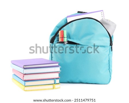 Backpack with different school stationery isolated on white