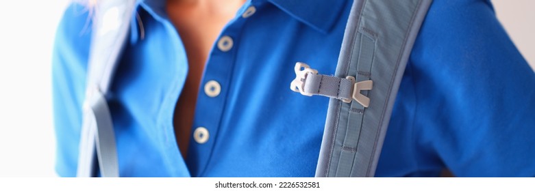 Backpack hanging on shoulders of woman in blue t-shirt closeup - Shutterstock ID 2226532581