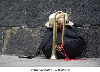 A Backpack, A Hat And A Cornet On The Street In A Recess Of A Marching Band Practice