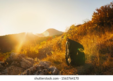 Backpack in the mountains at sunset while walking