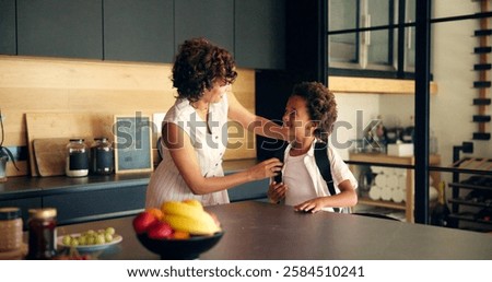 Backpack, school and mom with child in kitchen getting ready for morning routine, start day and learning. Family, home and mother with boy with bag for education, development and academy in house