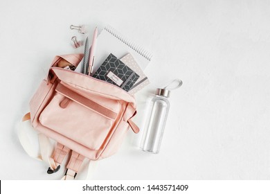 Backpack with school supplies and books for study. Back to school concept. Flat lay, top view 