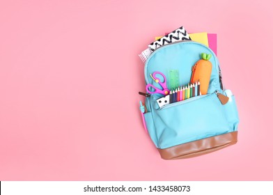 Backpack with school supplies top view on pink empty space background. - Shutterstock ID 1433458073
