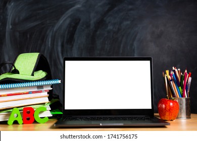 Backpack With Textbooks On The Table, An Open Laptop And Pencils, The Concept Of Modern Education. Nobody