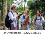 Backpack tourist travel outdoor adventure bird study using binoculars looking and record to book