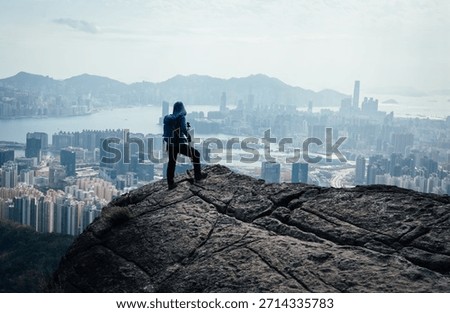 Backpacker climbing up the mountain cliff edge in Hong Kong
