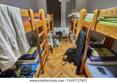 Backpacker dormitory room with bunk beds some mess