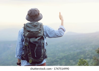 A backpacker to explore the mountains. Cliff