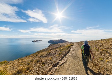 Backpacker exploring the Inca Trails on Island of the Sun, Titicaca Lake, among the most scenic travel destination in Bolivia. Travel adventures and vacations in the Americas. Shot in backlight.