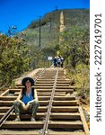 backpacker girl in hat hiking on steps of famous koko crater railway trailhead, oahu, hawaii, hiking in hawaii, holiday in hawaii