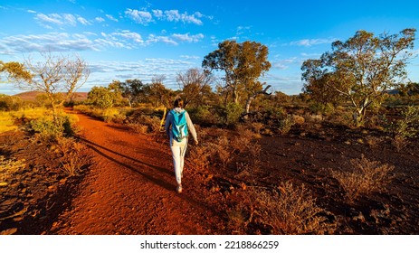 Backpacker Girl Hiking In Karijini National Park, Australia At Sunrise; Sunrise In The Red Desert In The Australian Outback