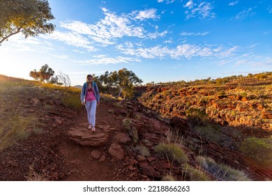 Backpacker Girl Hiking In Karijini National Park, Australia At Sunrise; Sunrise In The Red Desert In The Australian Outback