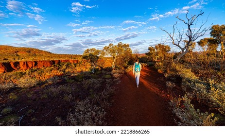 Backpacker Girl Hiking In Karijini National Park, Australia At Sunrise; Sunrise In The Red Desert In The Australian Outback