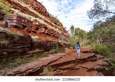 Backpacker Girl Hiking Through A Canyon In Karijini National Park In Western Australia, Hiking In The Australian Outback; Desert With Red Rocks