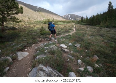 Backpacker on trail in the Collegiate Peaks Wilderness hiking towards Mount Belford