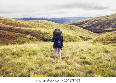 Backpacker standing in the middle of the wilderness