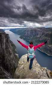 Backpacker In Victory Pose, Eagle Head Viewpoint Near Kjeragbolten 