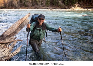 Backpacker Wade Rugged Mountain River