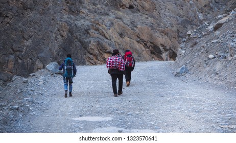 Backpacker walking in the mountains on Tibet, The Yading Nature Reserve in the Kham region of Sichuan is one of the most beautiful places on the Tibetan Plateau ,Daocheng, China.