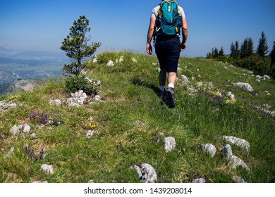 Backpacker walking up on mountain